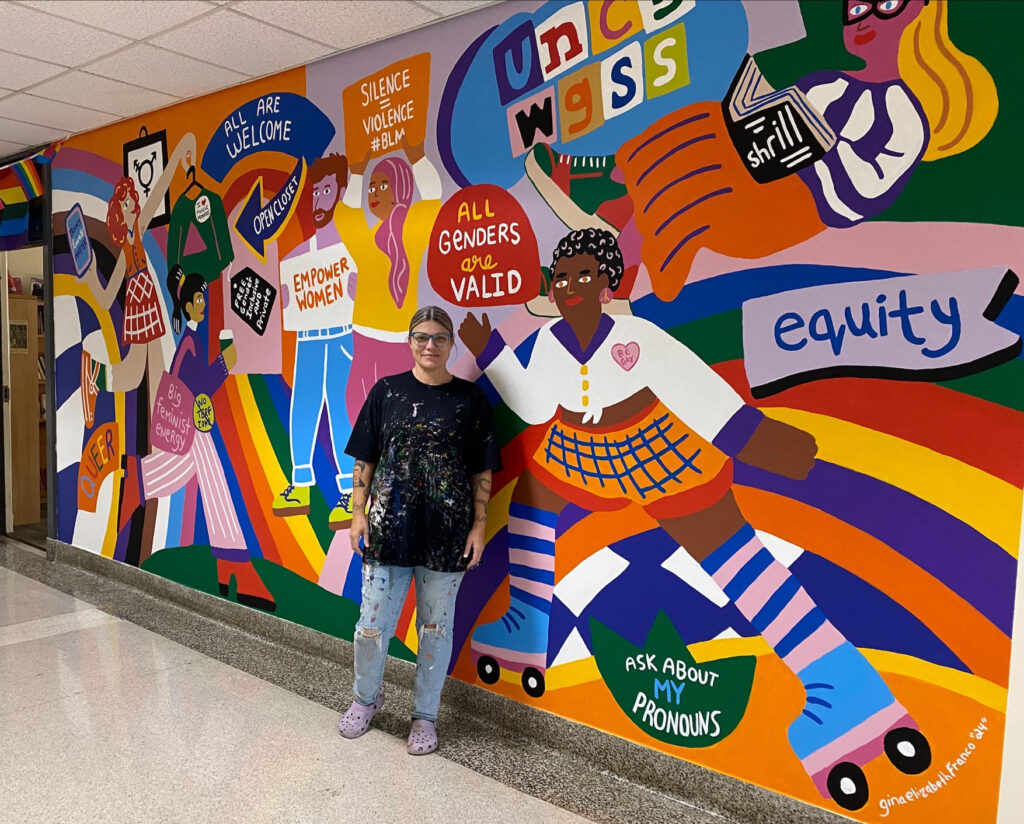 the mural by local artist Gina Franco featuring bright colors, images, and words to represent the WGSS community.