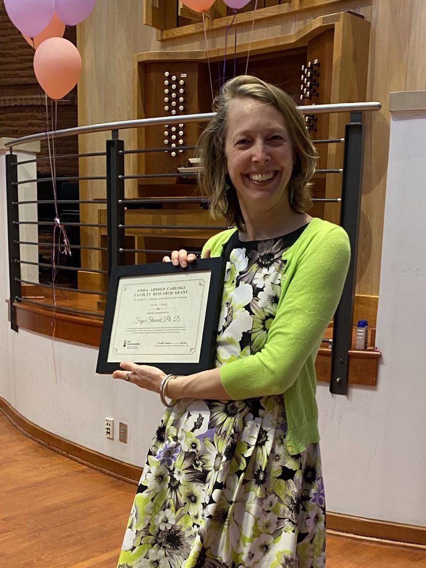 Faye Stewart holding her award